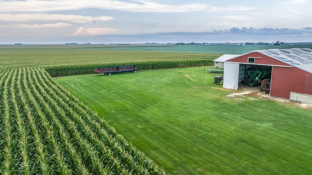 Red barn at the edge of the corn, aerial