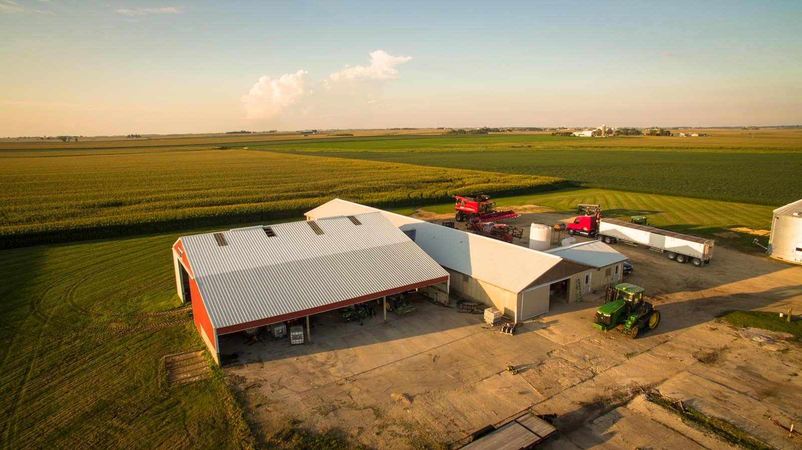 The farm compound at golden hour, aerial
